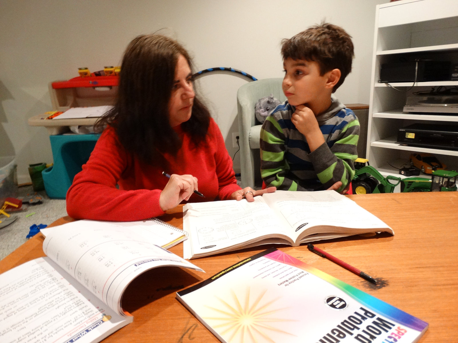 Anna tutoring an elementary student with a word problems book
